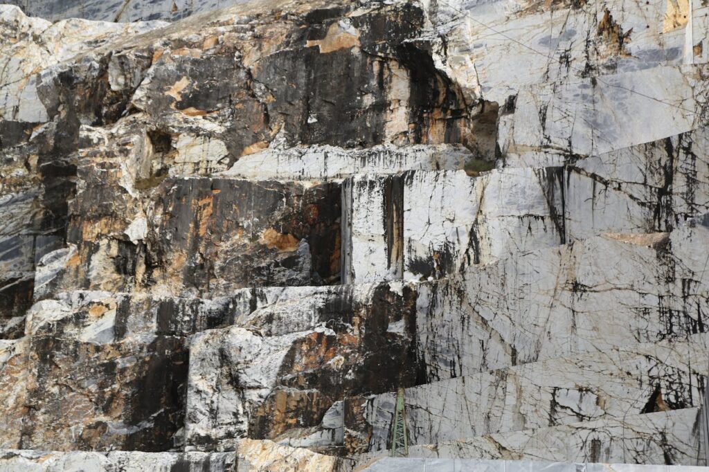 pexels photo 7000798 Close-up of Carrara marble quarry showcasing rock textures and patterns.